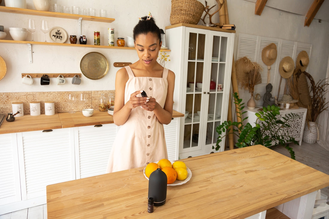 a woman standing in a kitchen looking at a cell phone
