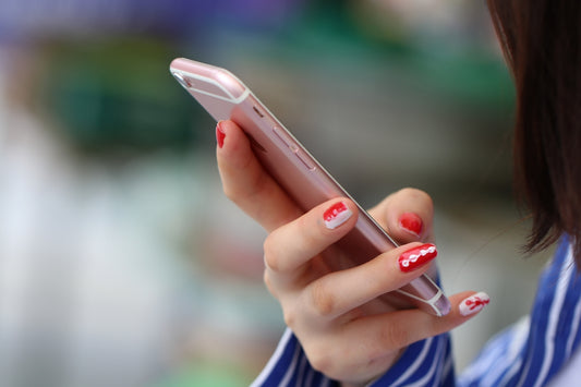 a woman holding a cell phone in her hand