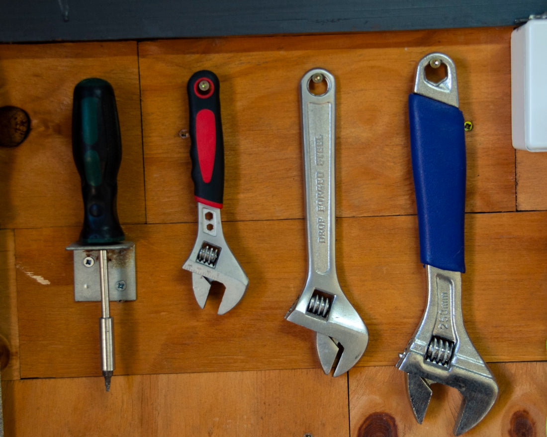 a bunch of tools are hanging on a wall