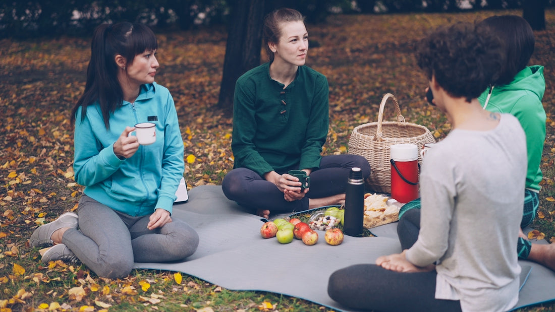 Four friends enjoying a picnic in the park